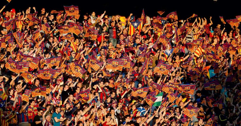 Torcedores do FC Barcelona torcendo por seus jogadores.